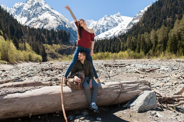 A guy and a girl taking a picture in the mountains